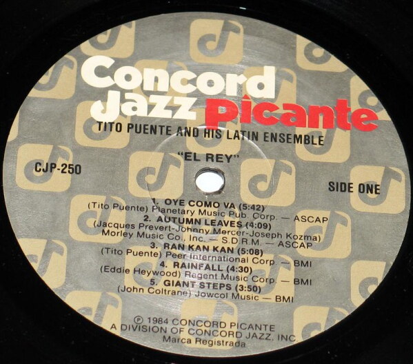 A close-up view of the middle of a vinyl record of Tito Puente and his Latin Ensemble, including the song Oye Como Va.