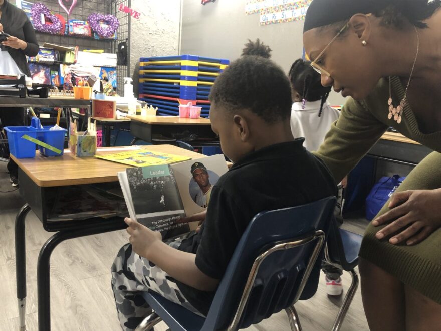 Five-year-old L.J. practices reading with a teacher at Infinity Generation Preparatory School.