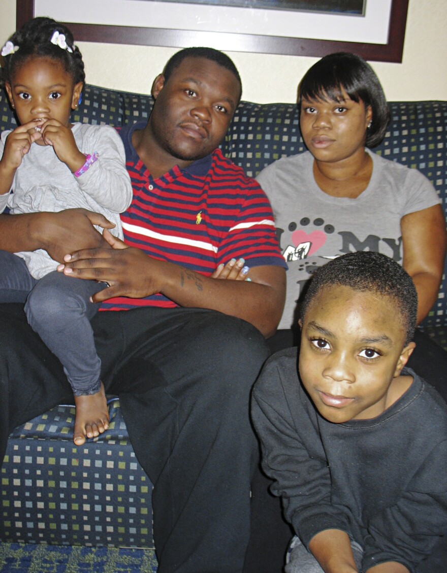 Natisha Laws and her partner, Mark Douglas, inside the Times Square hotel room where they've been staying since mid-November. The tourist hot spot is exciting for 3-year-old Tru and 9-year-old Isaiah, but their parents say they are stressed out and worry the family will end up homeless.