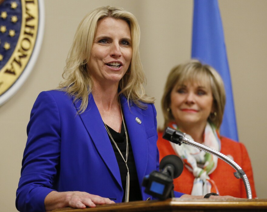 State Sen. A.J. Griffin, R-Guthrie (left), and Gov. Mary Fallin speak at a March 31, 2015 bill signing for a bill requiring doctors in Oklahoma to check a new prescription drug database before prescribing certain addictive drugs.