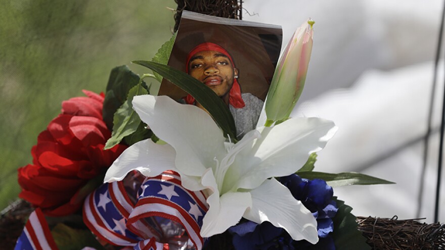 A photo of Dreasjon "Sean" Reed is placed in a memorial before a news conference, Wednesday, June 3, 2020, in Indianapolis. The family of Reed, a black man who was fatally shot by an Indianapolis police officer, called Wednesday for the federal government to intervene and conduct its own probe of his death.