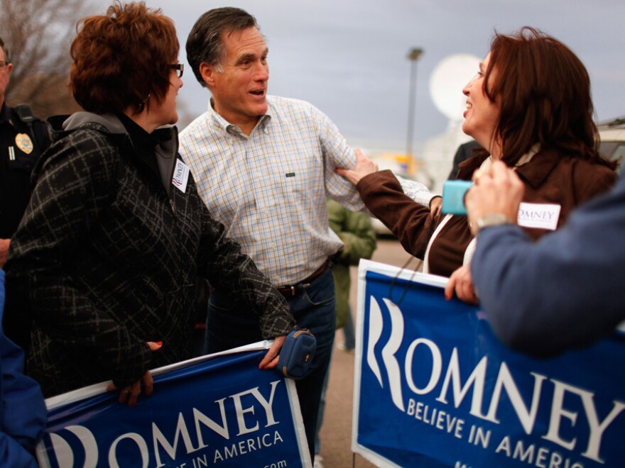 Republican presidential candidate Mitt Romney talks with supporters during a campaign event at the Family Table Restaurant in Le Mars, Iowa, in 2011.