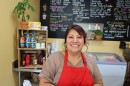 A woman smiling behind an ice cream counter