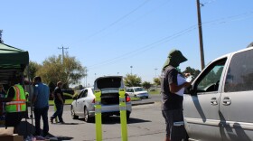 Othello Food Bank volunteers hand out food to customers at a recent drive-through event.