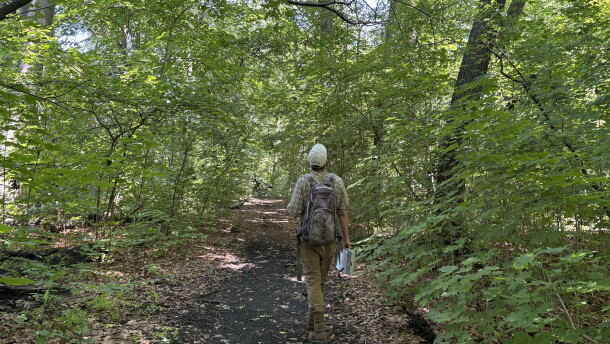 Southeast Wisconsin Regional Planning Commission biologist Zach Kron walking Seminary Woods. 