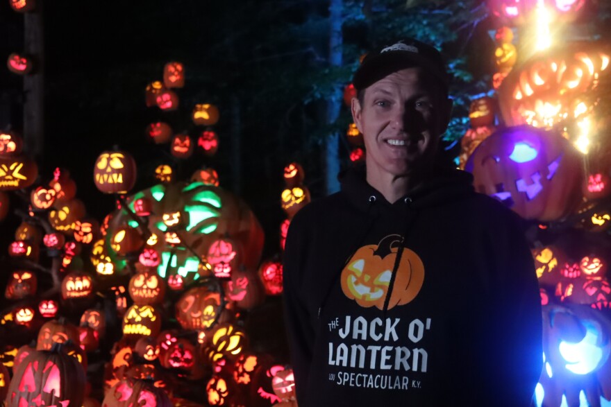Passion for Pumpkins leader Travis Reckner standing in front a portion of the 2025 Jack-O-Lantern Spectacular