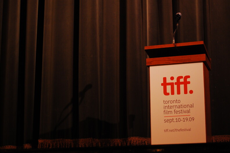 A mic sits atop a stand on a stage.