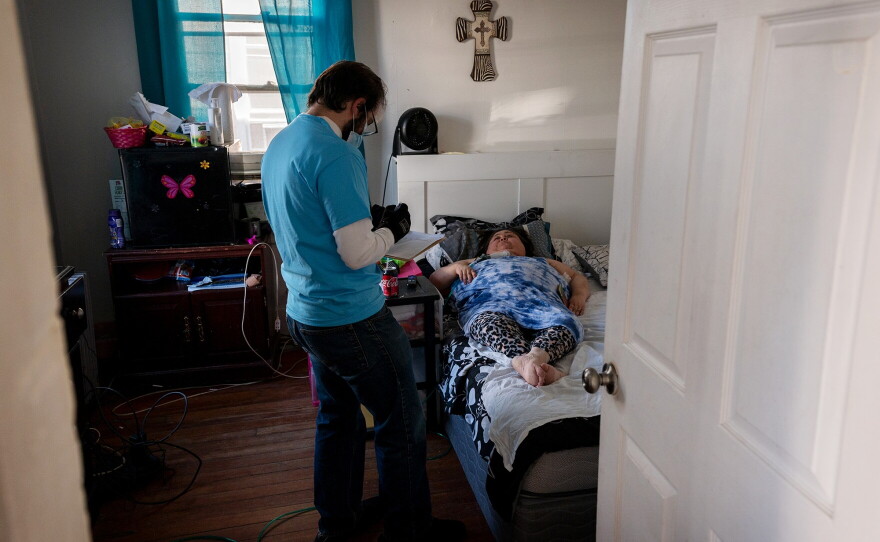 Volunteer Armando Ghinaglia speaks with a resident on March 13, 2021, during Vaccinate Fair Haven, an event organized to bring more equity to the COVID-19 vaccine rollout. About 265 people offered to walk door-to-door throughout Fair Haven, a neighborhood with a majority Black and Latino population, and register age-eligible residents for COVID-19 vaccine appointments.