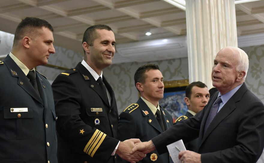 Sen. John McCain, right, shakes hand with Montenegrin army officers in Podgorica, Montenegro on April 12. McCain has congratulated Montenegro for its upcoming NATO membership.