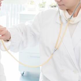 A nurse uses a stethoscope