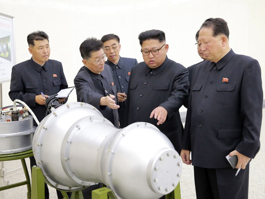 This undated picture released by North Korea's state-run news agency Sunday shows North Korean leader Kim Jong Un looking at what Pyongyang claims is a hydrogen bomb.