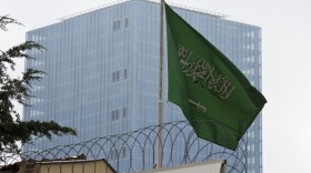 A Saudi Arabia flag flies on the roof of Saudi Arabia's consulate in Istanbul, Friday, Oct. 12, 2018. A senior Turkish official says Turkey and Saudi Arabia will form a "joint working group" to look into the disappearance of Saudi writer Jamal Khashoggi. (AP Photo/Petros Giannakouris)