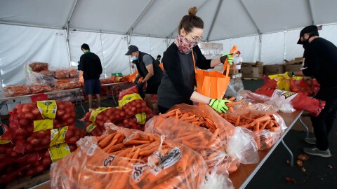 In this April 18, 2020, file photo, San Francisco-Marin Food Bank volunteers pack food into bags to be delivered to people in San Francisco. Food banks and anti-hunger advocates are bracing for the end of a pandemic-era boost in food assistance that the federal government has been providing for nearly three years.