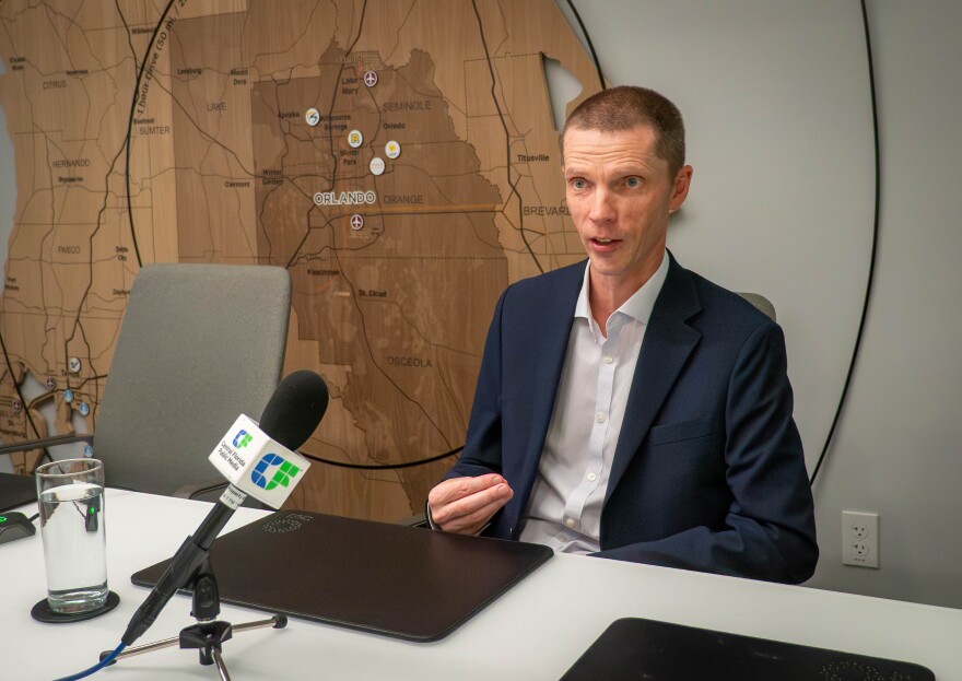 Neil Hamilton, senior vice president of research and strategy at the Orlando Economic Partnership, discusses his research into the local job market in an interview at OEP’s office in downtown Orlando on July 9, 2026. Companies in Central Florida are experimenting with using artificial intelligence to automate jobs, contributing to a recent slowdown in job growth in the region, he says.
