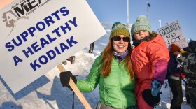 Physical therapist Alison Horn and her daughter Everly at AMEA’s informational picket on Saturday. (Photo by Kavitha George/KMXT)
