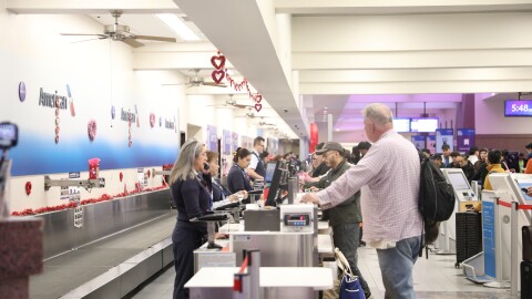 Passengers at the El Paso International Airport check on the status of their flights amid a temporary flight restriction for El Paso airspace. The TFR will last for 10 days, according to a notice from the Federal Aviation Administration.