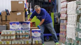 John Hoffman, a volunteer at the Dream Center in Bismarck, moves boxes of food from a pallet to a storage shelf Aug. 5, 2026.