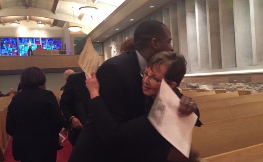 Man and woman hugging at the front of a church