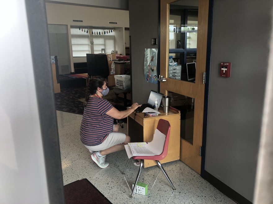 Smyrna Elementary School teacher Kerri Massey registers hot-spots and Chromebooks to students ahead of the school year.