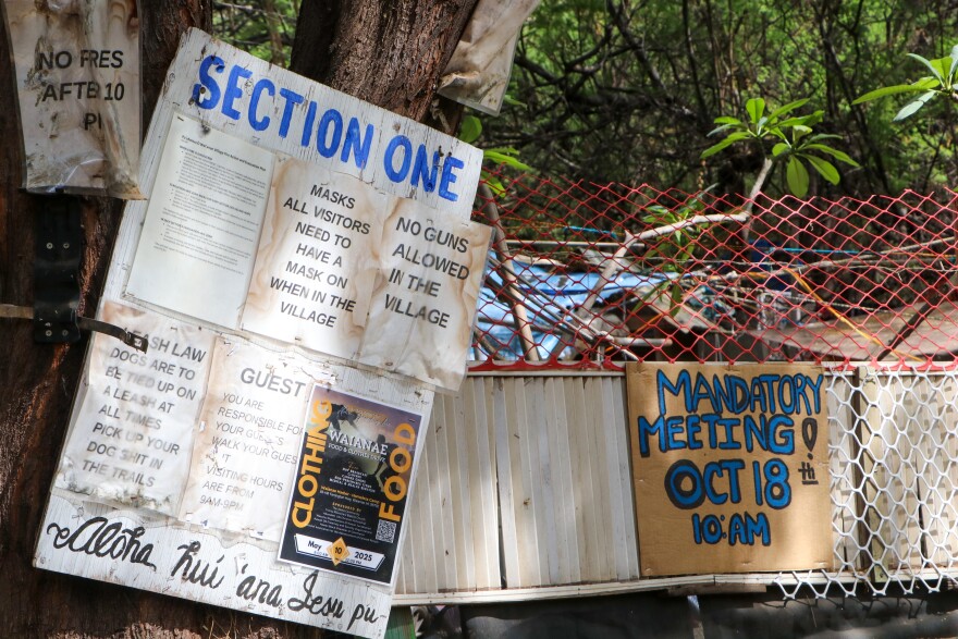 Community signs posted at POW village.