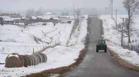 A farmer drives a tractor down a road near Ottawa, Illinois. 