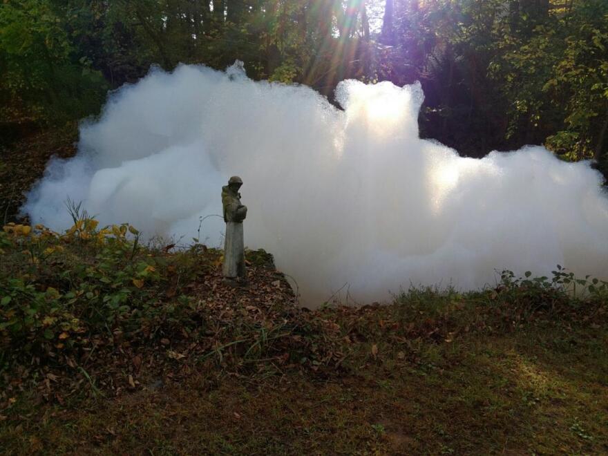 PFAS-filled aqueous film forming foam in the brook behind Paddy Abramowicz’s home in Windsor, Connecticut.