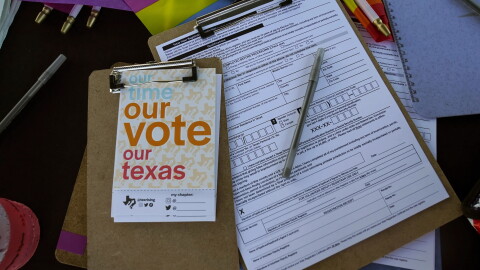 Voter registration applications are seen at the Texas Rising tent during a Pride celebration in Corpus Christi, Texas, on Oct. 5, 2024.