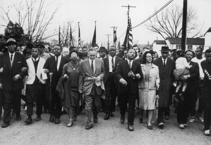 Martin Luther King and his wife Coretta Scott King lead a black voting rights march from Selma, Alabama, to the state capital in Montgomery. Among those pictured is the late civil rights activist and Congressman John Lewis, who died earlier this year.