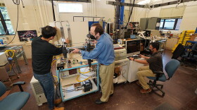 Purdue University Professor Issam Mudawar (center) working with students in his lab on their new charging cable design.