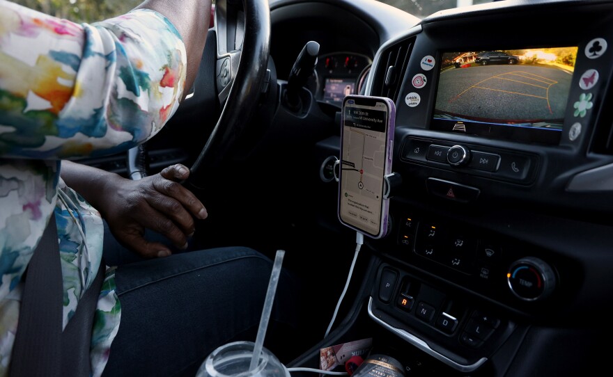 Jaquelyn “Jackie” King, a rideshare driver for the company Uber, backs out of a driveway in Gainesville, Fla., on Thursday, Nov. 20, 2025.