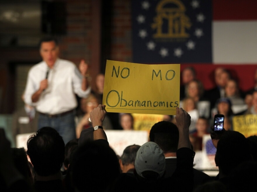 An audience member decries President Obama's economic policies as Republican presidential candidate Mitt Romney speaks during a February campaign rally in Atlanta.