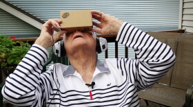 Dale Garrett of Columbia, Mo., a 96-year-old World War II veteran, experiences a trip to a war memorial through virtual reality.