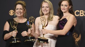 Ann Dowd, from left, winner of outstanding supporting actress in a drama series, Elisabeth Moss, winner of outstanding lead actress in a drama series, and Alexis Bledel, winner of outstanding guest actress in a drama for "The Handmaid's Tale" pose in the press room at the 69th Primetime Emmy Awards on Sunday, Sept. 17, 2017, at the Microsoft Theater in Los Angeles. (Jordan Strauss/Invision/AP)