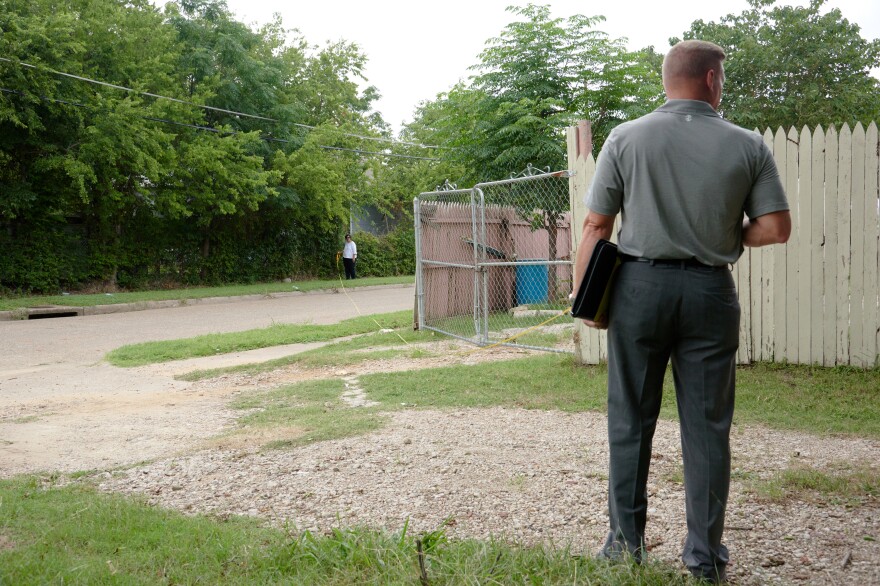 Cheryl Wattley and Daryl Parker measure the distance between locations at the crime scene in June 2017.