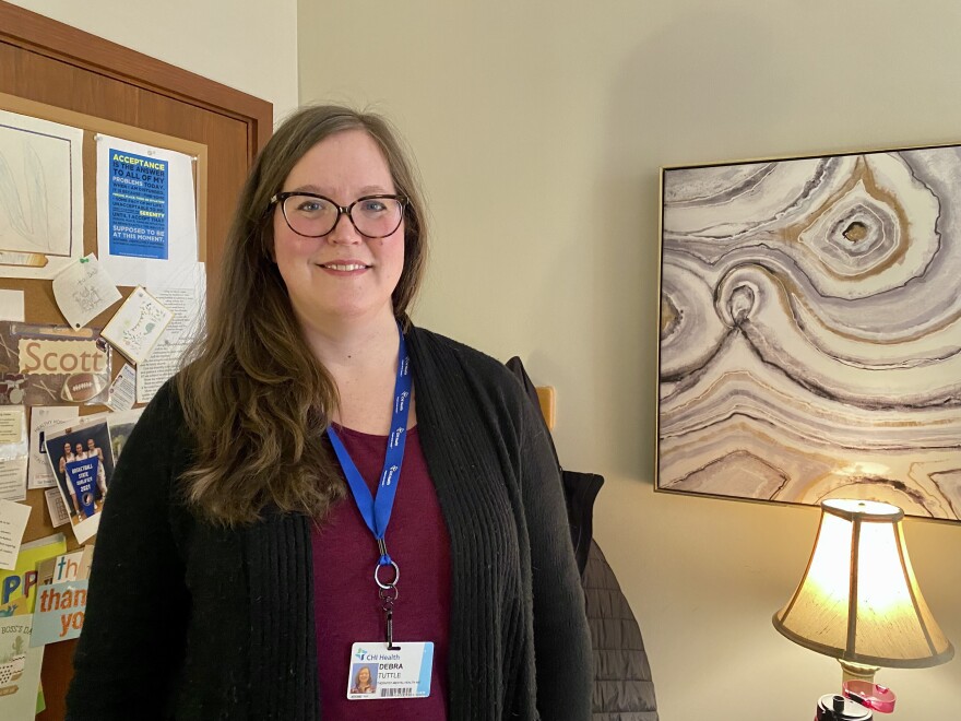 Deb Tuttle stands in her office at CHI Psychiatric Associates in Council Bluffs, Iowa.