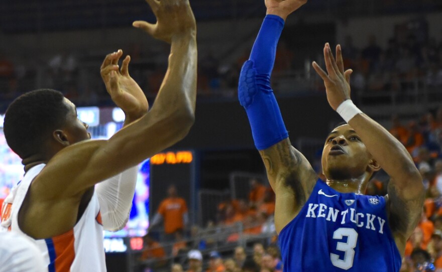 Kentucky’s Tyler Ulis (3) drives the lane and floats a shot over Florida’s Kevarrius Hayes (13) in the first half. Ulis was another Wildcat with a double-double, dishing out 11 assists and scoring 19 points. (Greenberry Taylor/WUFT News)