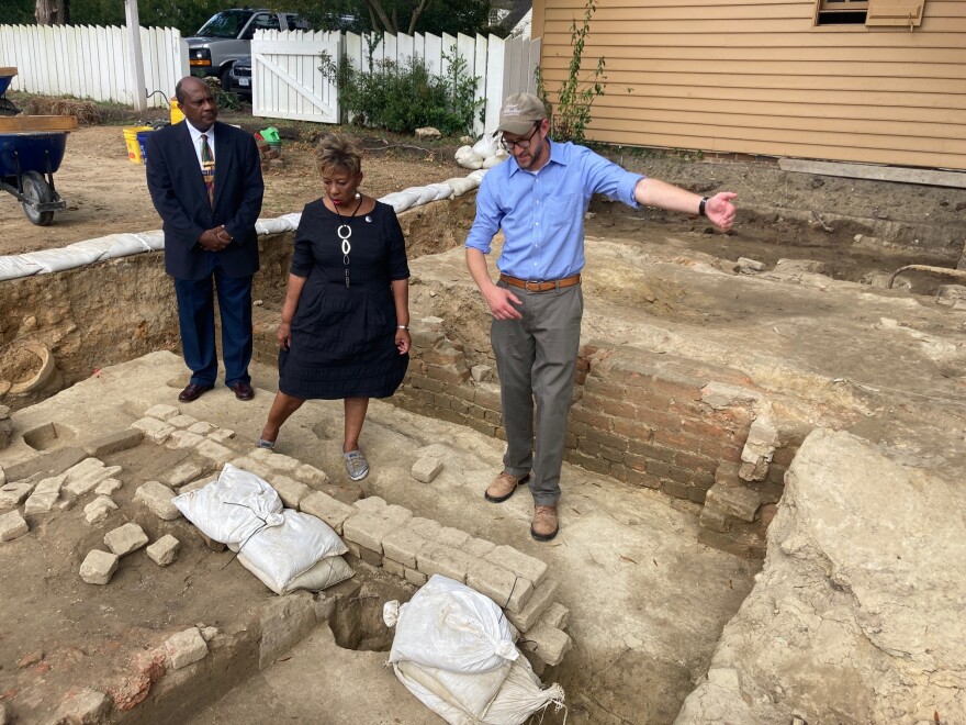From left, Reginald F. Davis, pastor of First Baptist Church, Connie Matthews Harshaw, a member of First Baptist, and Jack Gary, Colonial Williamsburg's director of archaeology, stand at the brick-and-mortar foundation of one the oldest Black churches in the U.S. on Oct. 6, 2021, in Williamsburg, Va.