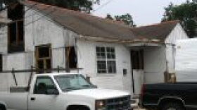 The Wischler's home, protected by plywood as they rebuild.