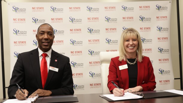 Don Hunt of NC State and Stacy Waters-Bailey of South Piedmont Community College sign the agreement to formalize the Wolfpack Connect program at South Piedmont.