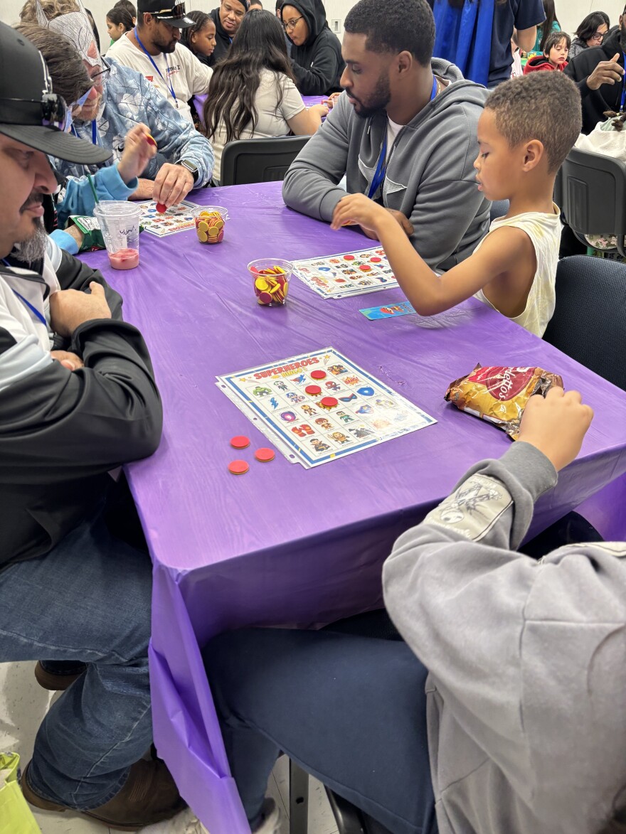 Fathers and kids play bingo together at the Strong Father/Child Saturday event from Northside ISD's Even Start program.