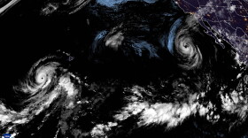 A satellite image shows from left to right, Hurricane Lowell, Tropical Storm Karina and Hurricane Marie in the Pacific on Saturday night.