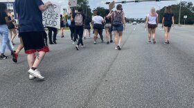 People march on Tallahassee’s north side. The group went all the way from midtown to here, up Thomasville Road, crossing under I-10. One of the busiest intersections in town in the afternoons came to a standstill as they passed