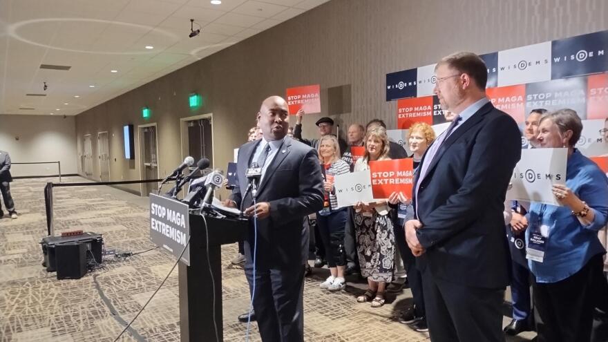 Democratic National Committee Chair Jaime Harrison looks at Wisconsin Democratic Party Chair Ben Wikler during a Saturday news conference at the state convention.