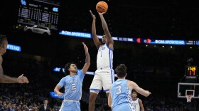 Kentucky guard Justin Edwards (1) shoots against North Carolina guard Elliot Cadeau (2) during the first half of an NCAA college basketball game in the CBS Sports Classic, Saturday, Dec. 16, 2023, in Atlanta, Ga. (AP Photo/Brynn Anderson)