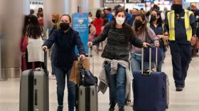 Passengers rush to check-in their luggage at Miami International Airport on Jan. 4, 2022.