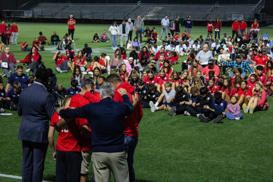 Wichita pastors pray with staff from McPherson City FC on Wednesday evening at the Stryker Sports Complex. Both victims of the deadly crash last weekend were from McPherson.