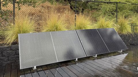 Plug-in solar panels sit on a home's outdoor deck.