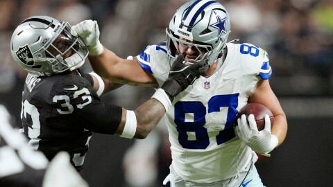 Dallas Cowboys tight end Jake Ferguson (87) tries to push Las Vegas Raiders linebacker Jamal Adams (33) aside during the second half of an NFL football game Monday, Nov. 17, 2025, in Las Vegas. (AP Photo/John Locher)