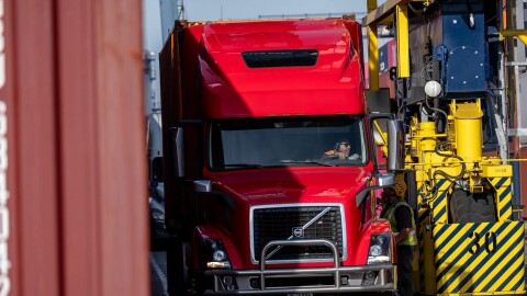 A truck driver prepares to leave after receiving a shipping container at Yusen Terminals at the Port of Los Angeles in San Pedro on Feb. 11, 2025.