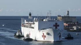 The Military Sealift Command hospital ship USNS Mercy (T-AH 19) arrives in Los Angeles, Calif., Friday, March 27, 2020. Mercy deployed in support of the nation's COVID-19 response efforts, and will serve as a referral hospital for non-COVID-19 patients currently admitted to shore-based hospitals. (Cpl. Alexa Hernandez/U.S. Marine Corps via AP)